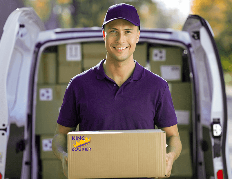 Delivery Driver holding a box, ready to deliver for King Courier.